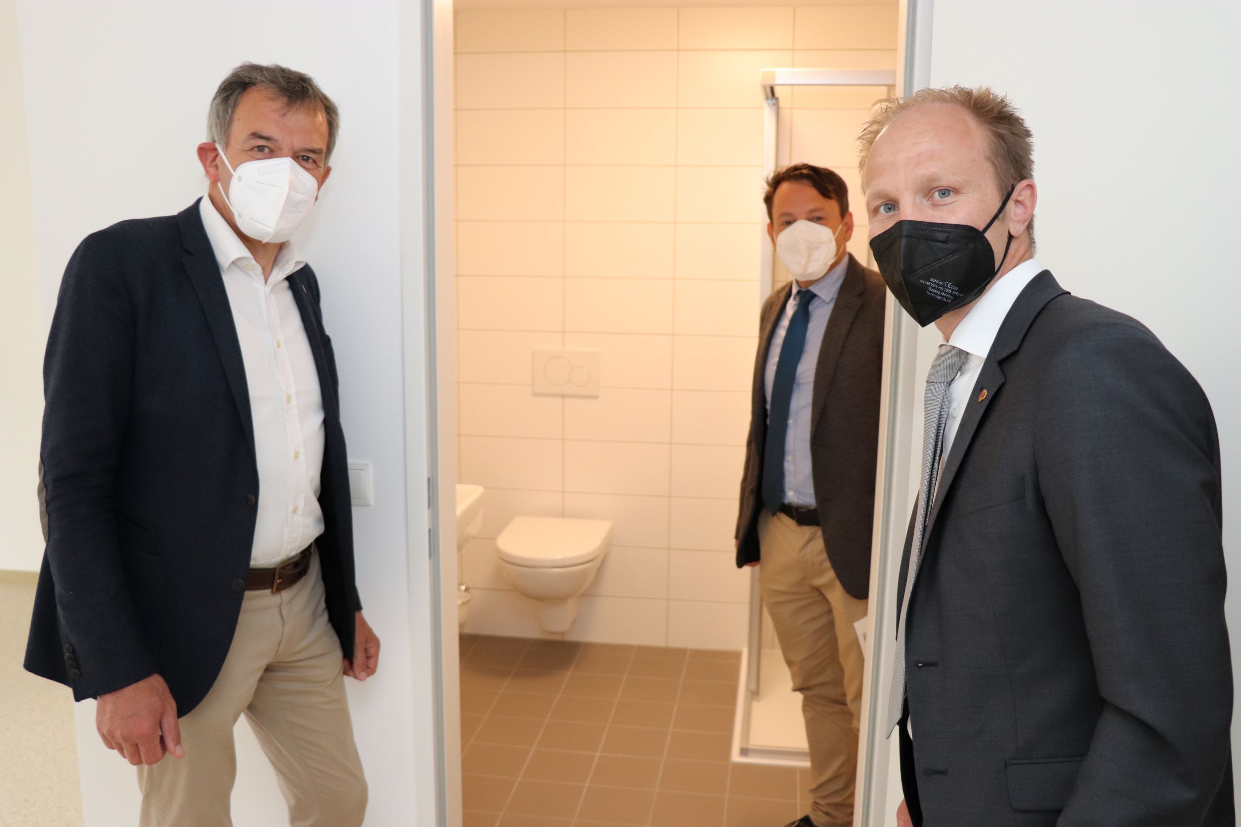 Bürgermeister Georg Willi, IIG-Geschäftsführer Franz Danler und Vizebürgermeister Johannes Anzengruber freuen sich über die neuen Sanitärbereiche, die mehr Privatsphäre schaffen.