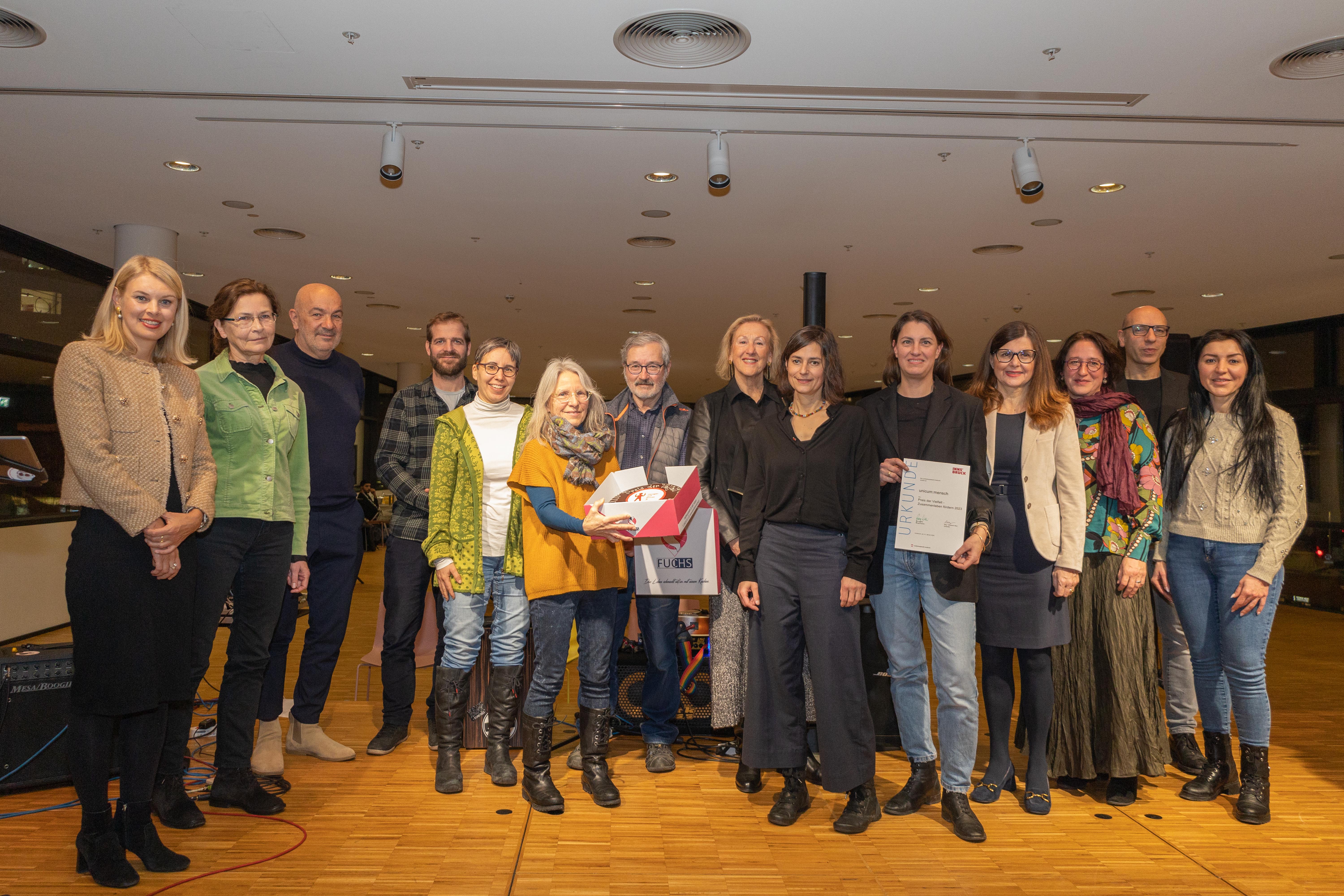 Integrationsstadträtin Elisabeth Mayr (l.) überreichte gemeinsam mit den Jurymitgliedern Gemeinderätin Brigitte Berchtold (4. v. r.), Meral Sevencan (r.), Wolfgang Andexlinger (2. v. r.) und Konrad Lais (4. v. l.) sowie der Laudatorin Professorin Ursula Costa (3. v. r.) den Preis der Vielfalt 2023 an den Verein unicum:mensch für den Kulturpass und die Kulturbuddies. Jenny Illing (5. v. r.) und Teresa Waas (6. v. r.) vom Verein unicum:mensch und die anwesenden Kulturbuddies nahmen die Auszeichnung in der Stadtbibliothek entgegen.