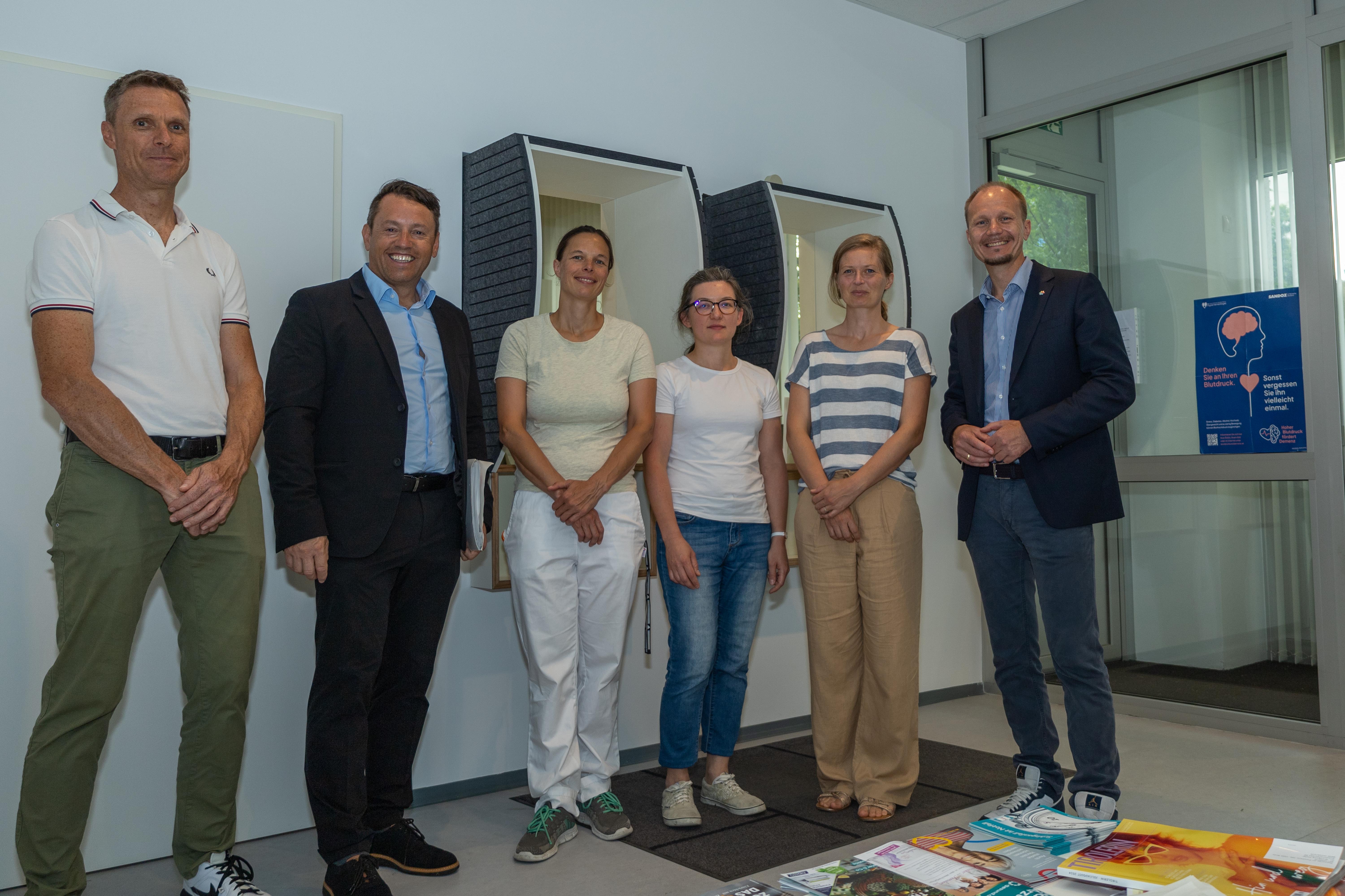 BU: Die Erweiterung der Arztpraxis in der Schützenstraße verbessert die medizinische Versorgung im Stadtteil O-Dorf. (v. l. n. r.): Bernhard Matt (IIG-Geschäftsbereich Objektmanagement), IIG-Geschäftsführer Franz Danler, die Ärztinnen Gerda Görig, Anna Marczak, Stefanie Vill, sowie Bürgermeister Johannes Anzengruber in den neuen Räumlichkeiten der Gemeinschaftspraxis.